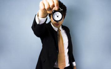 Man Using a Clock to Time Association Meeting